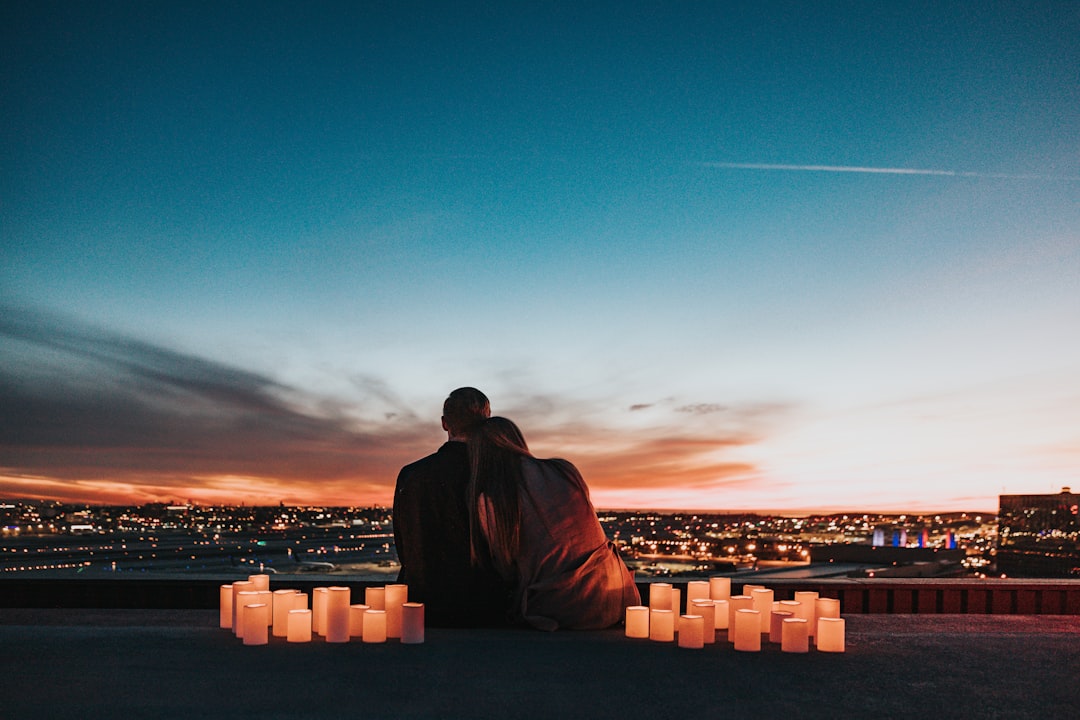 Unconventional couple sitting apart from the city lights, reflecting the independent Aquarius soulmate connection