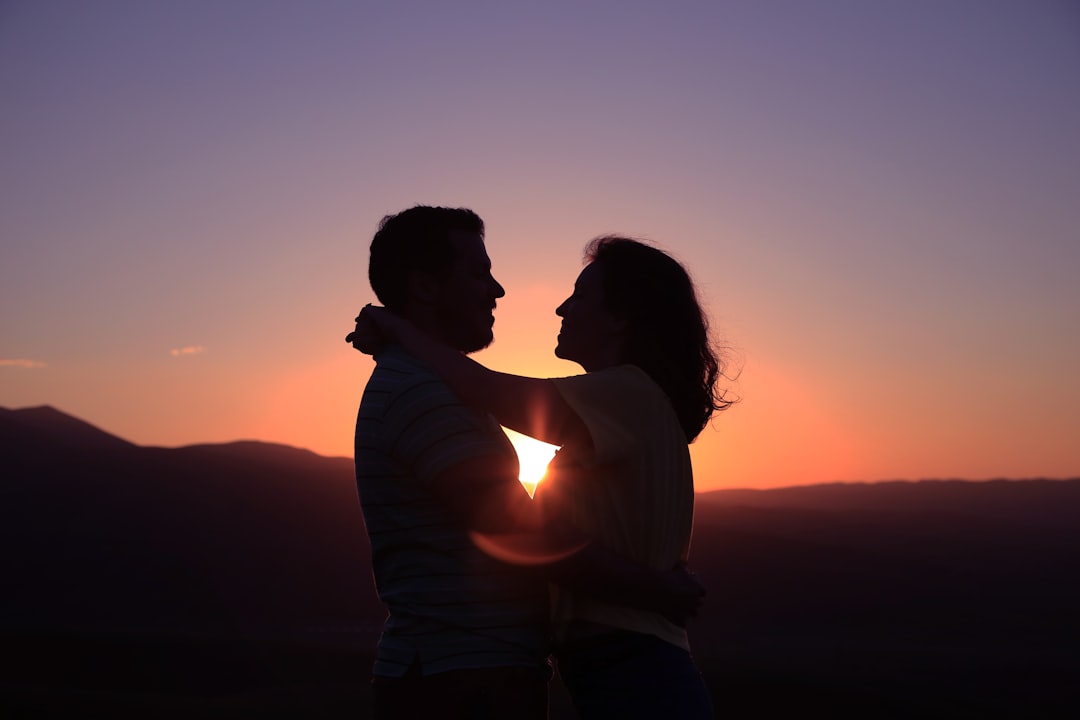 Passionate couple embracing at sunset, symbolizing the fiery love an Aries soulmate brings