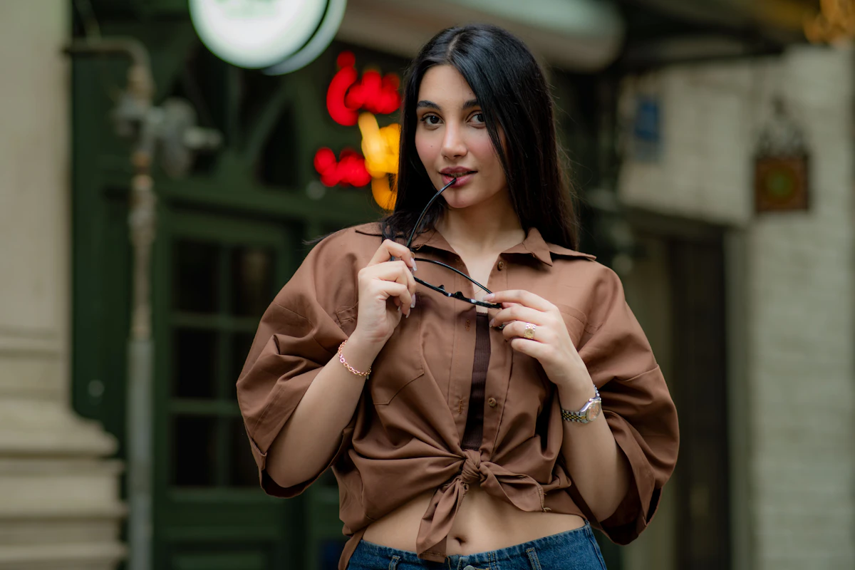 Young woman in a street style outfit with brown jeans