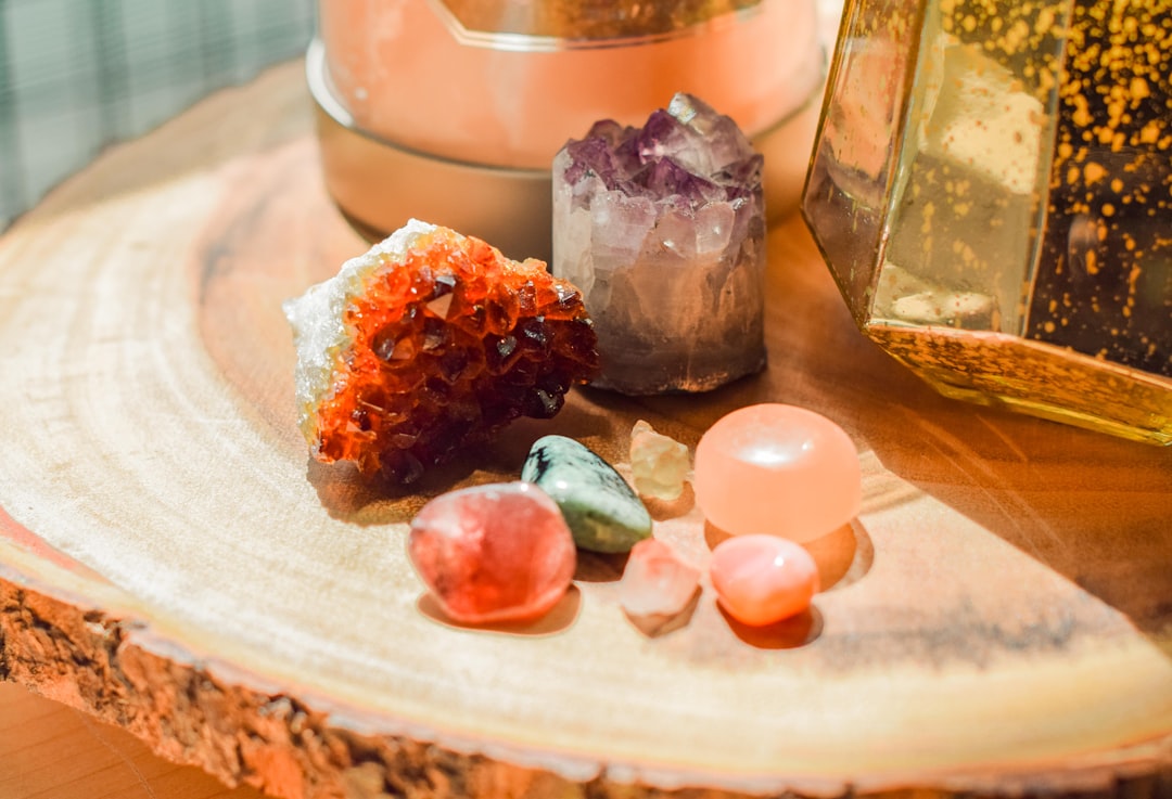 Assorted healing crystals arranged on a wooden table for a cleansing ritual