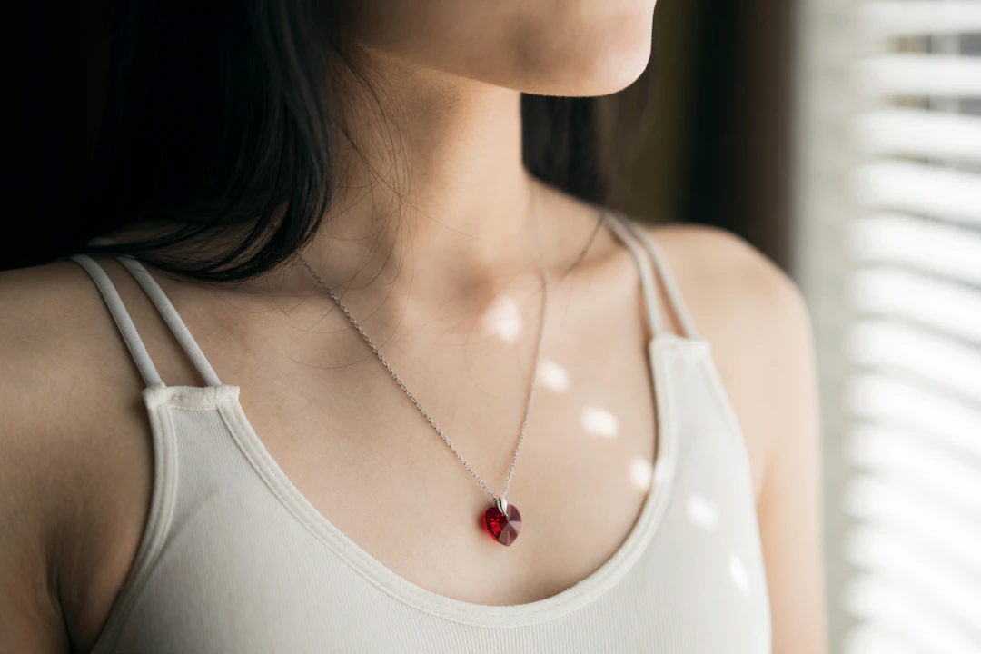Woman wearing a crystal pendant necklace — mystical pendant jewelry for a Scorpio woman