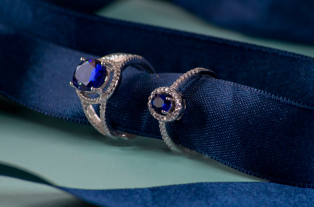 Pair of deep blue sapphire rings on velvet ribbon — blue sapphire 10th anniversary gift