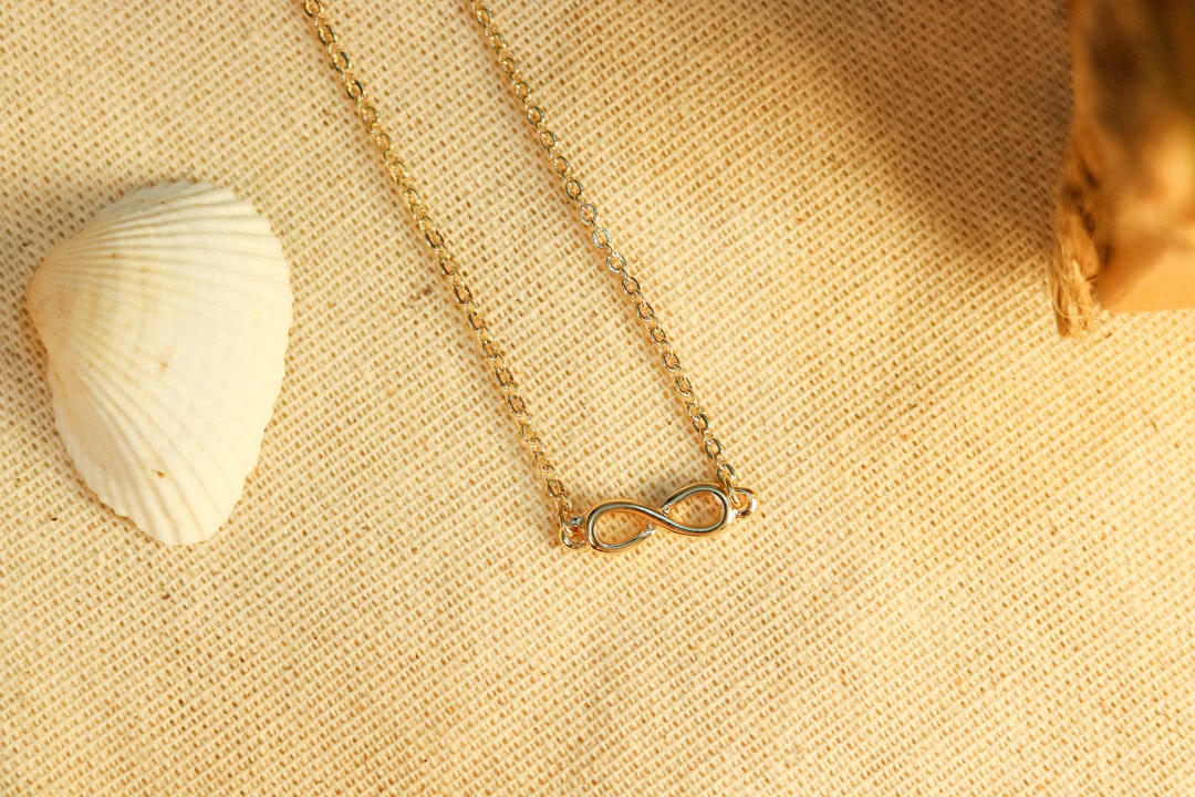 Delicate chain necklace on white linen — quality craftsmanship Virgo women appreciate