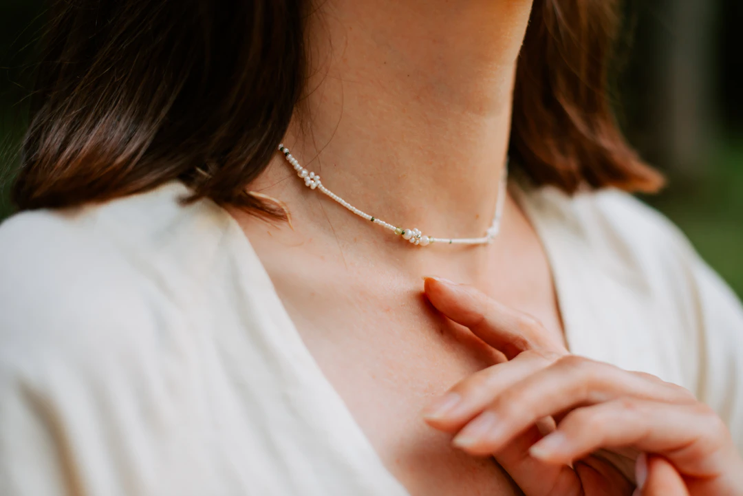 Close up of a woman wearing a delicate necklace — sentimental everyday jewelry for Cancer women