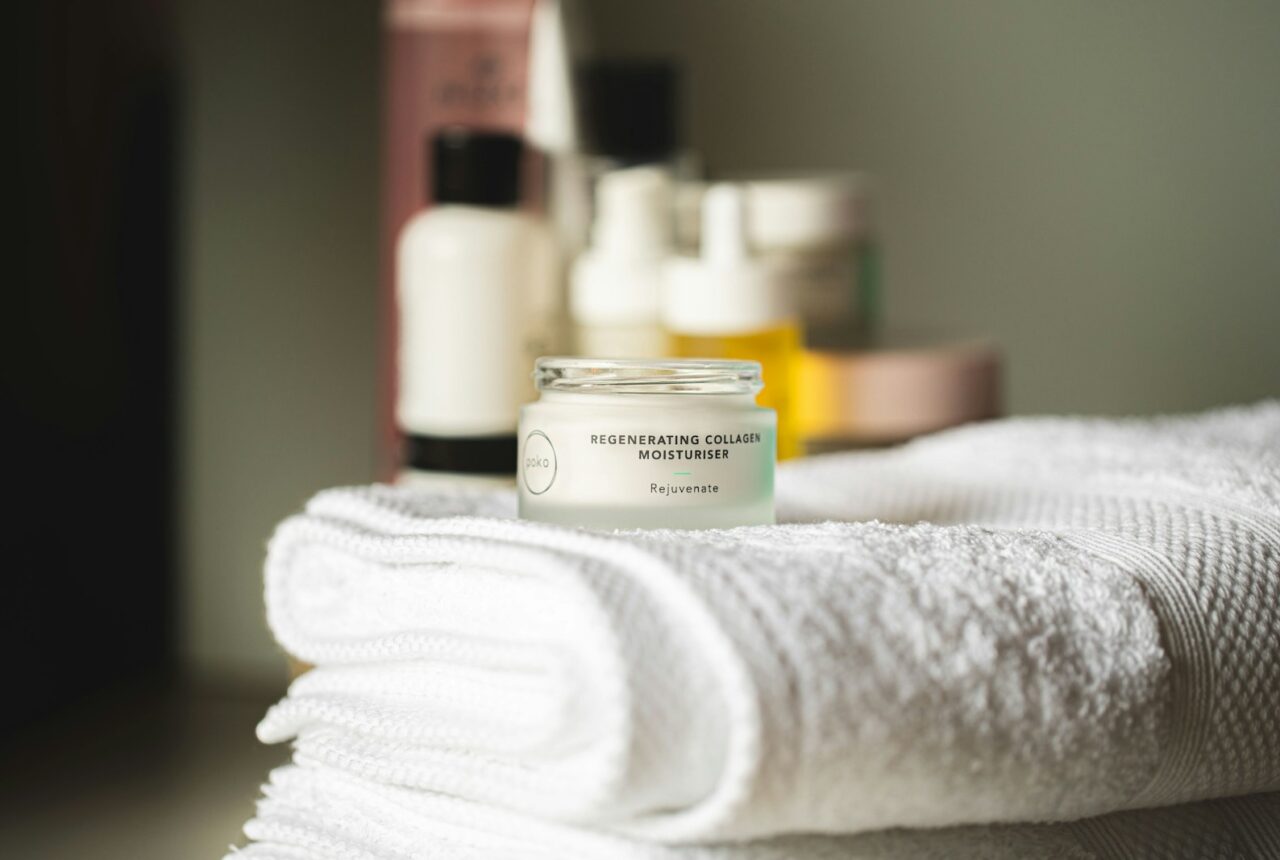 Minimal fragrance-free skincare products on a bathroom shelf, suited to sensitive skin