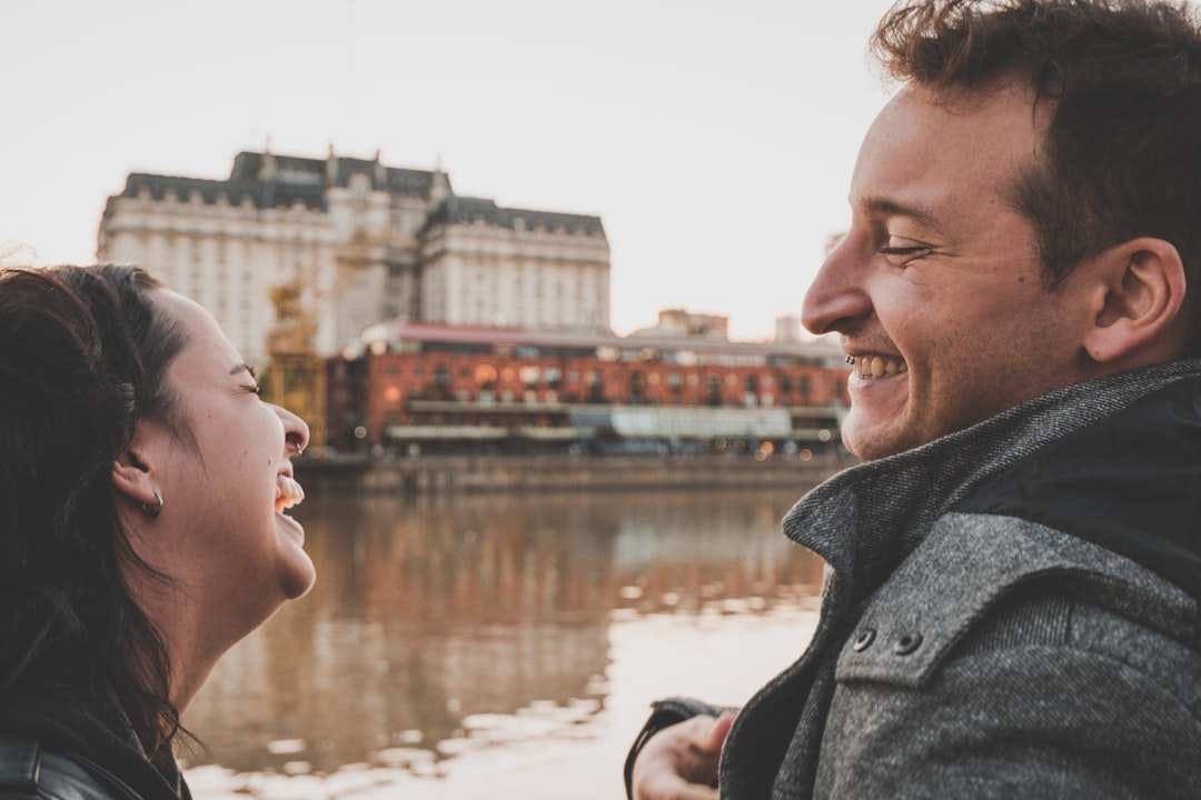 Happy couple laughing together, the lively conversation a Gemini soulmate thrives on