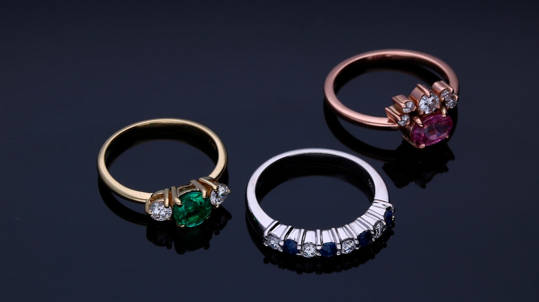 Three rings set with diamonds and colored precious stones — anniversary gemstone jewelry