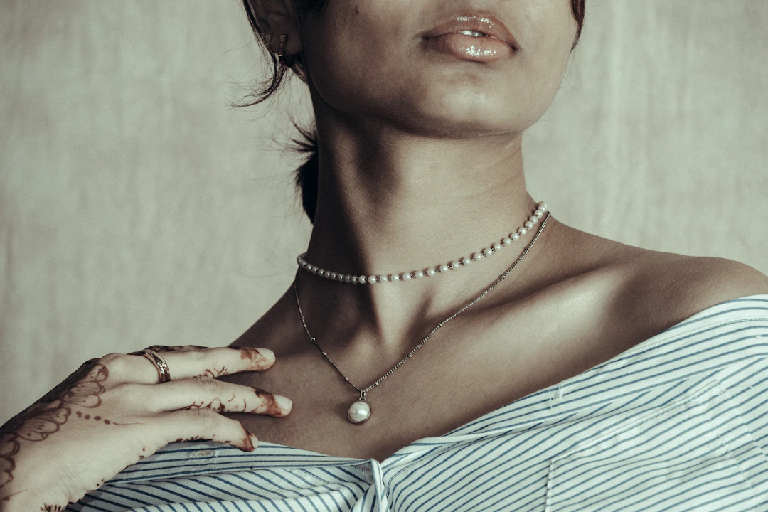 Woman in soft light wearing pearls — gentle sentimental jewelry gifts for Cancer women