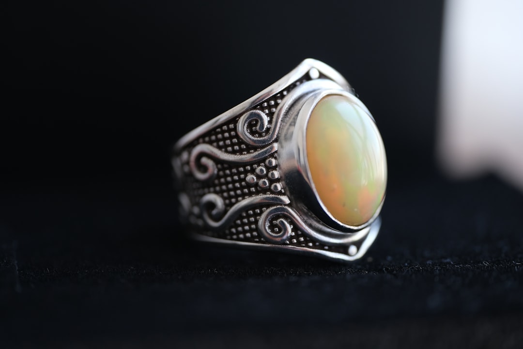 Silver ring with an oval opal, Libra's iridescent October birthstone