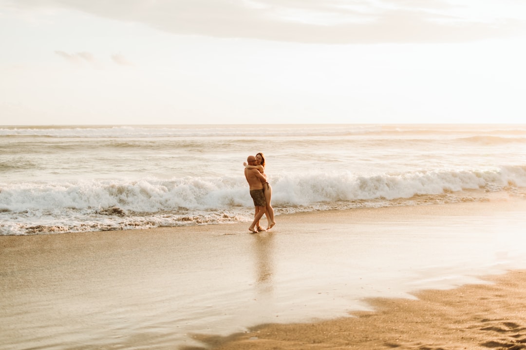 Couple embracing on the beach at sunset, symbolizing a Pisces soulmate connection