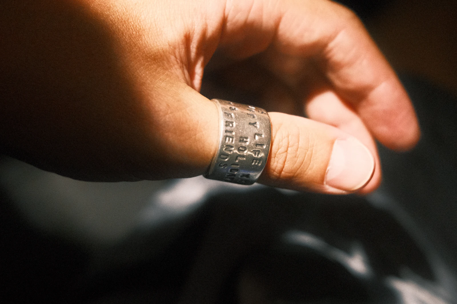 Close-up of a gold ring showing band width that affects ring sizing