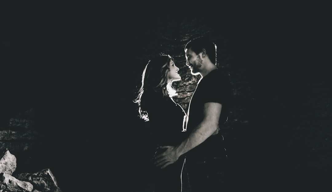 Intense couple facing each other in moody light, symbolizing the deep emotional bond a Scorpio soulmate creates
