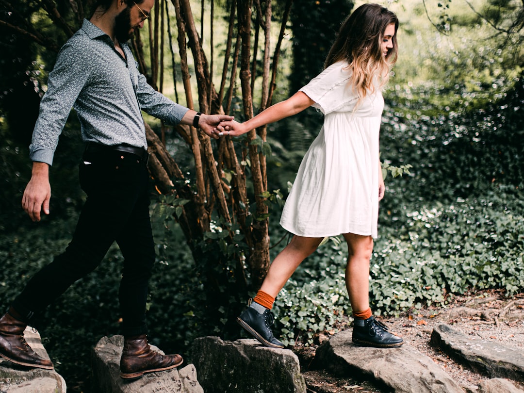 Couple holding hands on a quiet forest walk, the steady devotion a Virgo soulmate offers