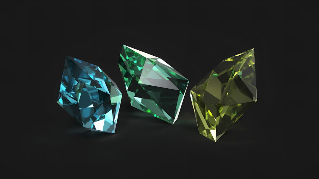 Three colored gemstones on a black background — wedding anniversary gemstones by year