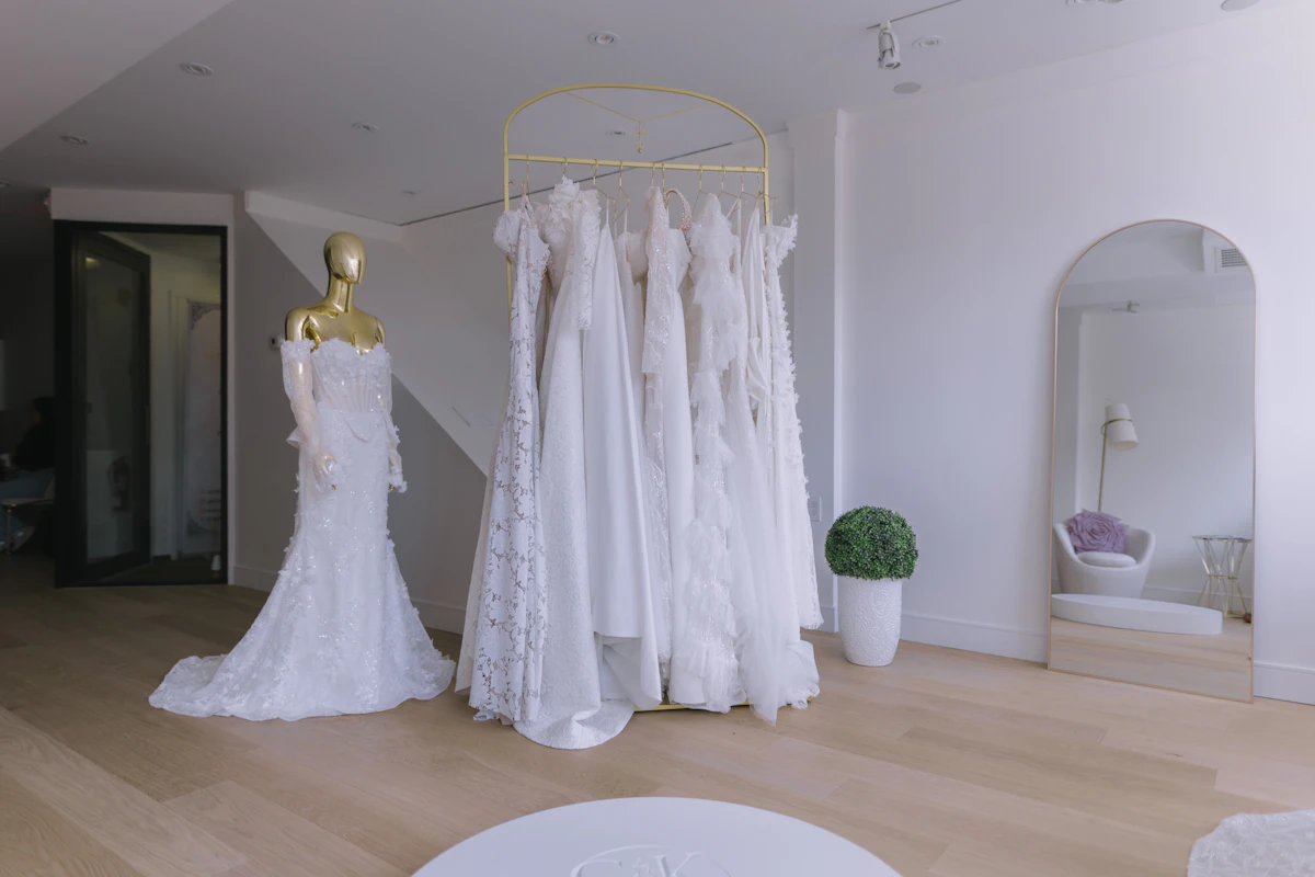 Wedding dresses on a gold rack in a modern bridal boutique
