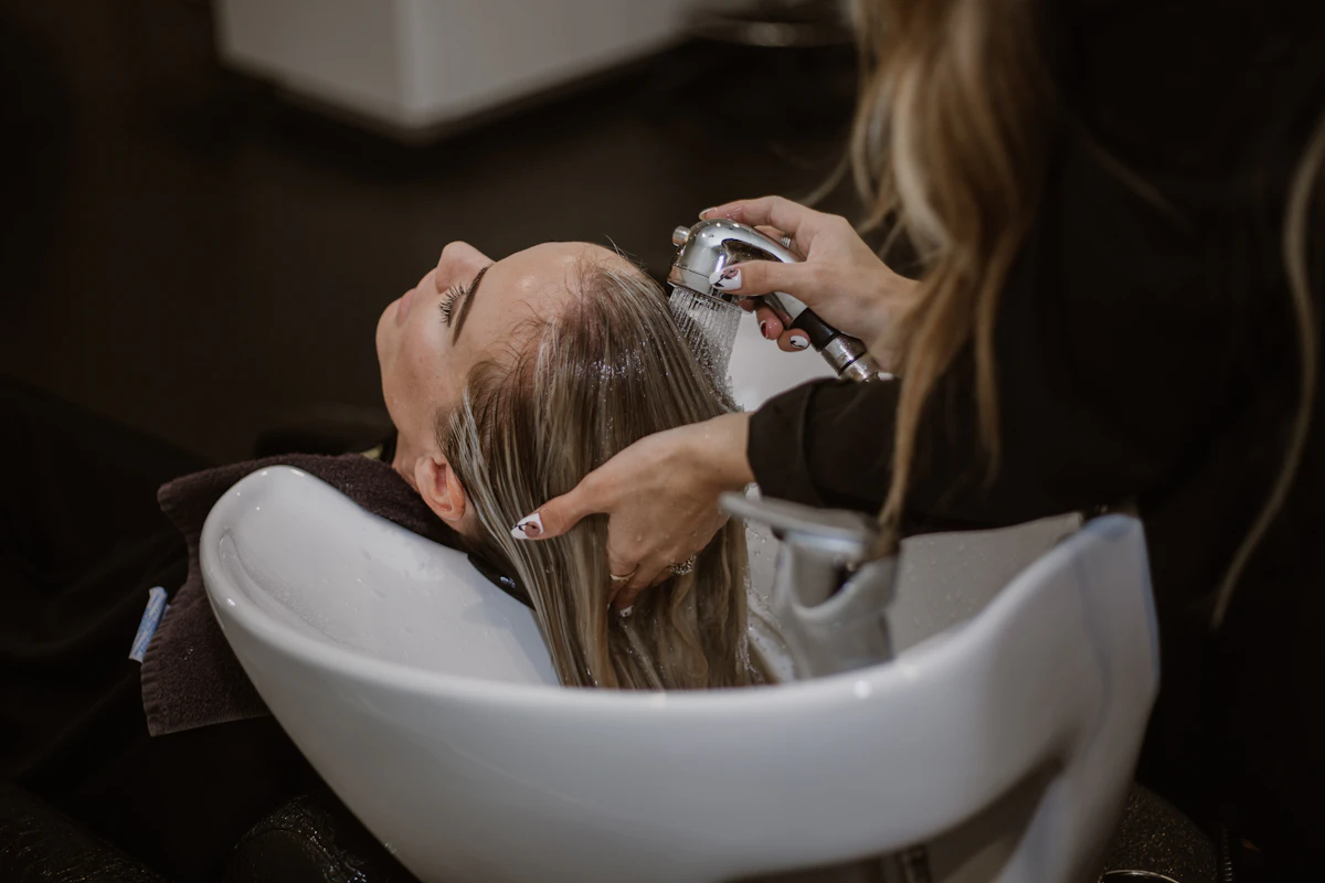 Woman getting a short haircut from a stylist at the salon
