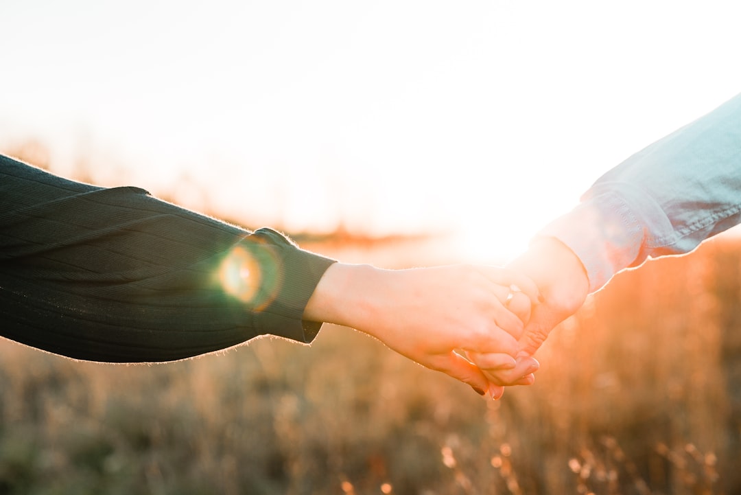Couple holding hands at sunset symbolizing zodiac soulmate compatibility