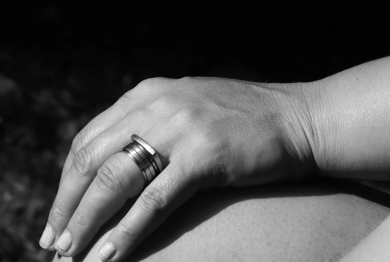 Silver ring worn on a hand showing how metal reads against skin undertone