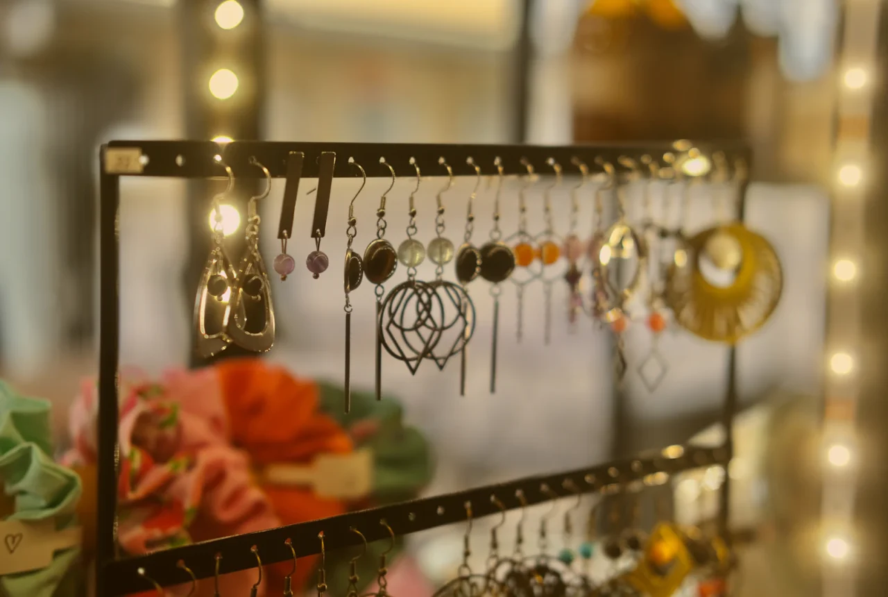 Rack displaying many types of earrings including hoops studs and drops