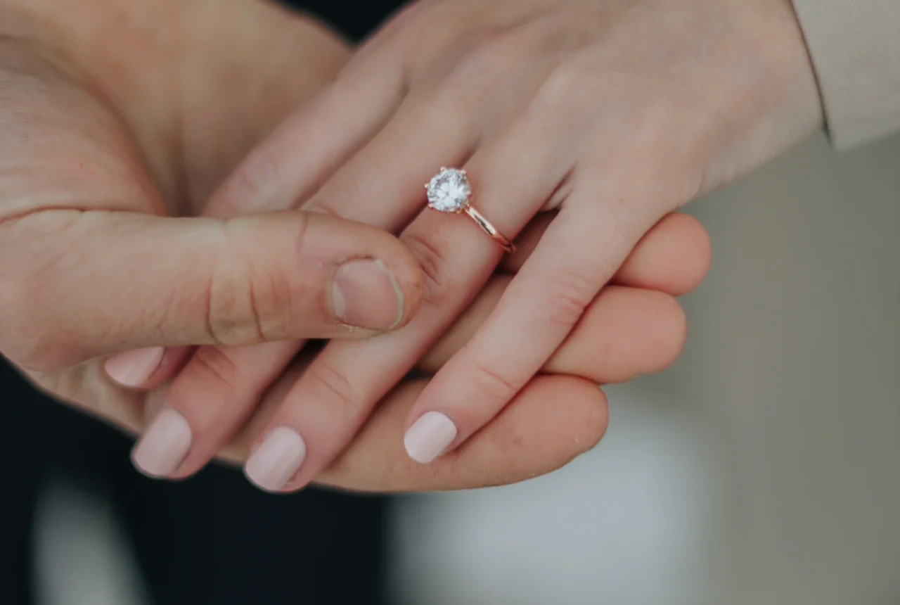 Hand wearing a promise ring